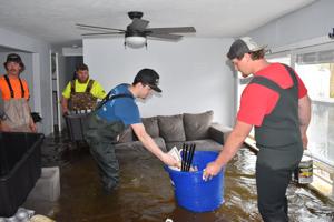 Friends, family help recover items from flooded home
