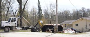 Neighborhood along Manistee River searching, finding help following flooding